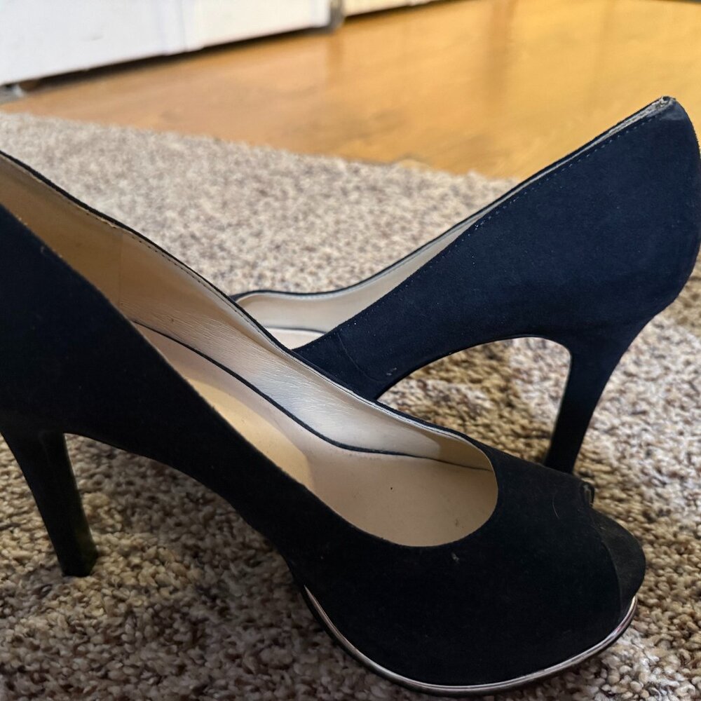 Navy suede high-heel pumps with a peep-toe and a slim stiletto heel.